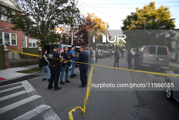 Police guard the crime scene. The New York City Police Department investigates after a man is killed by a gunshot to the head in the East El...