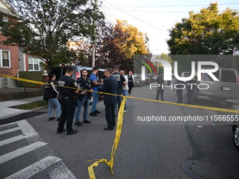 Police guard the crime scene. The New York City Police Department investigates after a man is killed by a gunshot to the head in the East El...