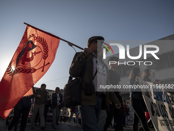 A person raises a communist flag in a march commemorating the 51st anniversary of the coup in Chile. (