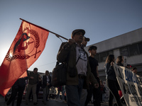 A person raises a communist flag in a march commemorating the 51st anniversary of the coup in Chile. (