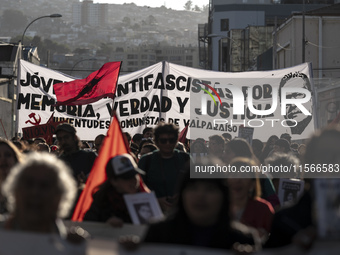 Protesters raise a banner with the figure of Salvador Allende in a commemorative march in Chile on September 11, 2024, 51 years after the co...