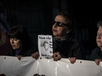 A person carries a photograph of a disappeared detainee in a march commemorating the 51st anniversary of the coup in Chile. (