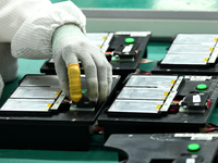 Workers rush to make computer and tablet battery orders at a workshop in Hai'an, China, on September 11, 2024. (