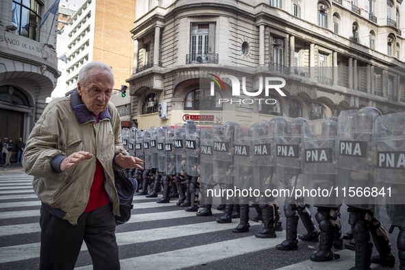 Protesters, including retirees and families, gather outside Argentina's National Congress following President Javier Milei's veto of the Mob...