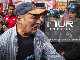 Protesters, including retirees and families, gather outside Argentina's National Congress following President Javier Milei's veto of the Mob...