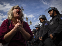 Protesters, including retirees and families, gather outside Argentina's National Congress following President Javier Milei's veto of the Mob...