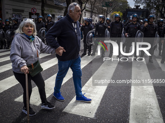 Protesters, including retirees and families, gather outside Argentina's National Congress following President Javier Milei's veto of the Mob...