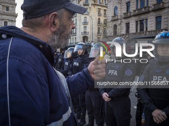 Protesters, including retirees and families, gather outside Argentina's National Congress following President Javier Milei's veto of the Mob...