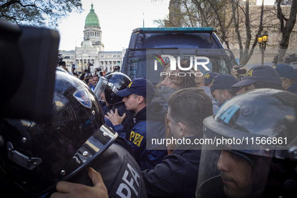 Protesters, including retirees and families, gather outside Argentina's National Congress following President Javier Milei's veto of the Mob...