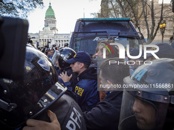 Protesters, including retirees and families, gather outside Argentina's National Congress following President Javier Milei's veto of the Mob...