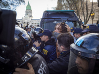 Protesters, including retirees and families, gather outside Argentina's National Congress following President Javier Milei's veto of the Mob...