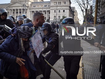 Protesters, including retirees and families, gather outside Argentina's National Congress following President Javier Milei's veto of the Mob...