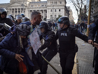 Protesters, including retirees and families, gather outside Argentina's National Congress following President Javier Milei's veto of the Mob...