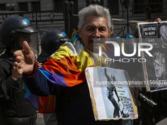 Protesters, including retirees and families, gather outside Argentina's National Congress following President Javier Milei's veto of the Mob...