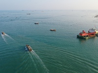 Workers work in a breeding area at a marine ranch in Dinghai Bay, Lianjiang County in Fuzhou, China, on September 10, 2024. (