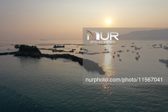 Workers work in a breeding area at a marine ranch in Dinghai Bay, Lianjiang County in Fuzhou, China, on September 10, 2024. 