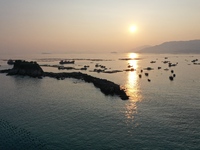 Workers work in a breeding area at a marine ranch in Dinghai Bay, Lianjiang County in Fuzhou, China, on September 10, 2024. (