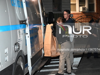 Crime scene investigators collect evidence at the scene where a man is killed by a shot to the head in Queens, New York, on September 11, 20...