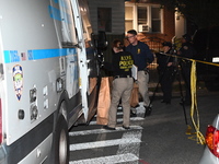 Crime scene investigators collect evidence at the scene where a man is killed by a shot to the head in Queens, New York, on September 11, 20...