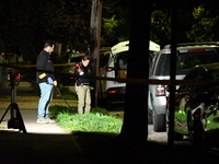 Crime scene investigators collect evidence at the scene where a man is killed by a shot to the head in Queens, New York, on September 11, 20...