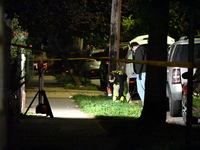 Crime scene investigators collect evidence at the scene where a man is killed by a shot to the head in Queens, New York, on September 11, 20...