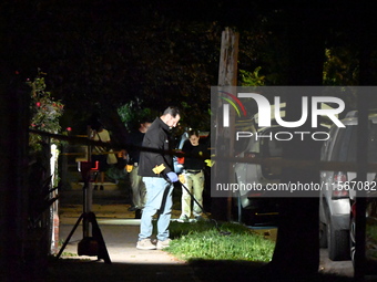 Crime scene investigators collect evidence at the scene where a man is killed by a shot to the head in Queens, New York, on September 11, 20...