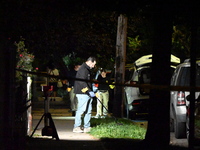 Crime scene investigators collect evidence at the scene where a man is killed by a shot to the head in Queens, New York, on September 11, 20...