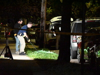 Crime scene investigators collect evidence at the scene where a man is killed by a shot to the head in Queens, New York, on September 11, 20...