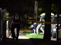 Crime scene investigators collect evidence at the scene where a man is killed by a shot to the head in Queens, New York, on September 11, 20...