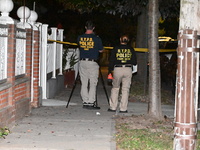 Crime scene investigators collect evidence at the scene where a man is killed by a shot to the head in Queens, New York, on September 11, 20...