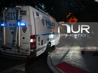 Crime scene investigators collect evidence at the scene where a man is killed by a shot to the head in Queens, New York, on September 11, 20...