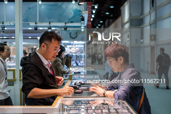 Visitors and exhibitors attend the 70th gems and jewelry fair in Bangkok, Thailand. The trade show is one of the most important events of it...