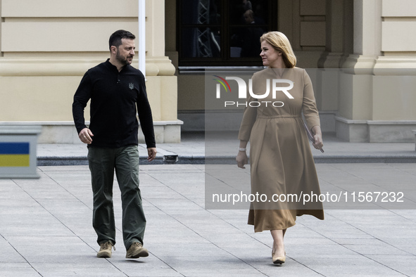 Ukrainian President Volodymyr Zelenskiy and Latvia's Prime Minister Evika Silina arrive for a joint press conference in Kyiv, Ukraine, on Se...