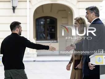 Ukrainian President Volodymyr Zelenskiy, Latvia's Prime Minister Evika Silina, and Croatia's Prime Minister Andrej Plenkovic shake hands aft...