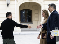 Ukrainian President Volodymyr Zelenskiy, Latvia's Prime Minister Evika Silina, and Croatia's Prime Minister Andrej Plenkovic shake hands aft...