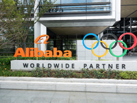 The Alibaba logo and the Olympic Rings are seen at the entrance of the Alibaba Campus on the West Bank of Xuhui in Shanghai, China, on Septe...