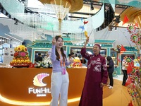 Visitors experience the traditional Beijing toy ''Swallow Windmill'' at the Cultural and Tourism Service exhibition area at the China Beijin...