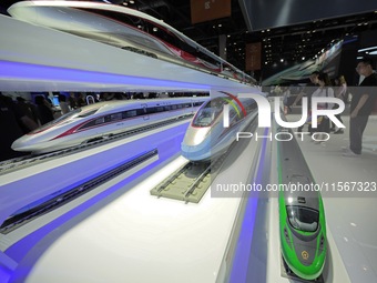 Visitors learn about China's high-speed rail technology at the booth of China Academy of Railway Sciences at the 2024 China Beijing Internat...