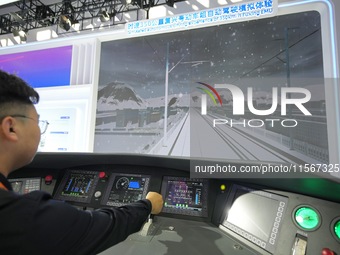 Spectators experience a simulated driver of the Fuxing EMU at the 2024 China Beijing International Fair for Trade in Services (CIFTIS) in Be...