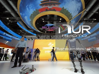 Spectators watch a humanoid robot perform at the China Beijing International Fair for Trade in Services (CIFTIS) in Beijing, China, on Septe...