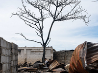 Children help remove the debris of damaged houses following a huge fire that engulfs at least 800 houses in Bacoor, Cavite, the Philippines,...