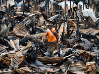 A man looks for salvageable items among the rubble of damaged houses following a huge fire that engulfs at least 800 houses in Bacoor, Cavit...