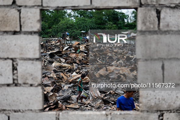 In Bacoor, Cavite, the Philippines, on September 12, 2024, people look for salvageable items among the rubble of damaged houses following a...