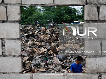 In Bacoor, Cavite, the Philippines, on September 12, 2024, people look for salvageable items among the rubble of damaged houses following a...