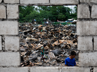 In Bacoor, Cavite, the Philippines, on September 12, 2024, people look for salvageable items among the rubble of damaged houses following a...