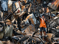 A man looks for salvageable items among the rubble of damaged houses following a huge fire that engulfs at least 800 houses in Bacoor, Cavit...