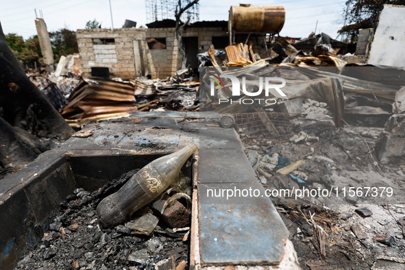 A Coca-Cola glass bottle is seen among the rubble of a damaged house following a huge fire that engulfs at least 800 houses in Bacoor, Cavit...