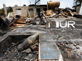 A Coca-Cola glass bottle is seen among the rubble of a damaged house following a huge fire that engulfs at least 800 houses in Bacoor, Cavit...