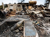 A Coca-Cola glass bottle is seen among the rubble of a damaged house following a huge fire that engulfs at least 800 houses in Bacoor, Cavit...