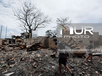 People look for salvageable items among the rubble of damaged houses following a huge fire that engulfs at least 800 houses in Bacoor, Cavit...